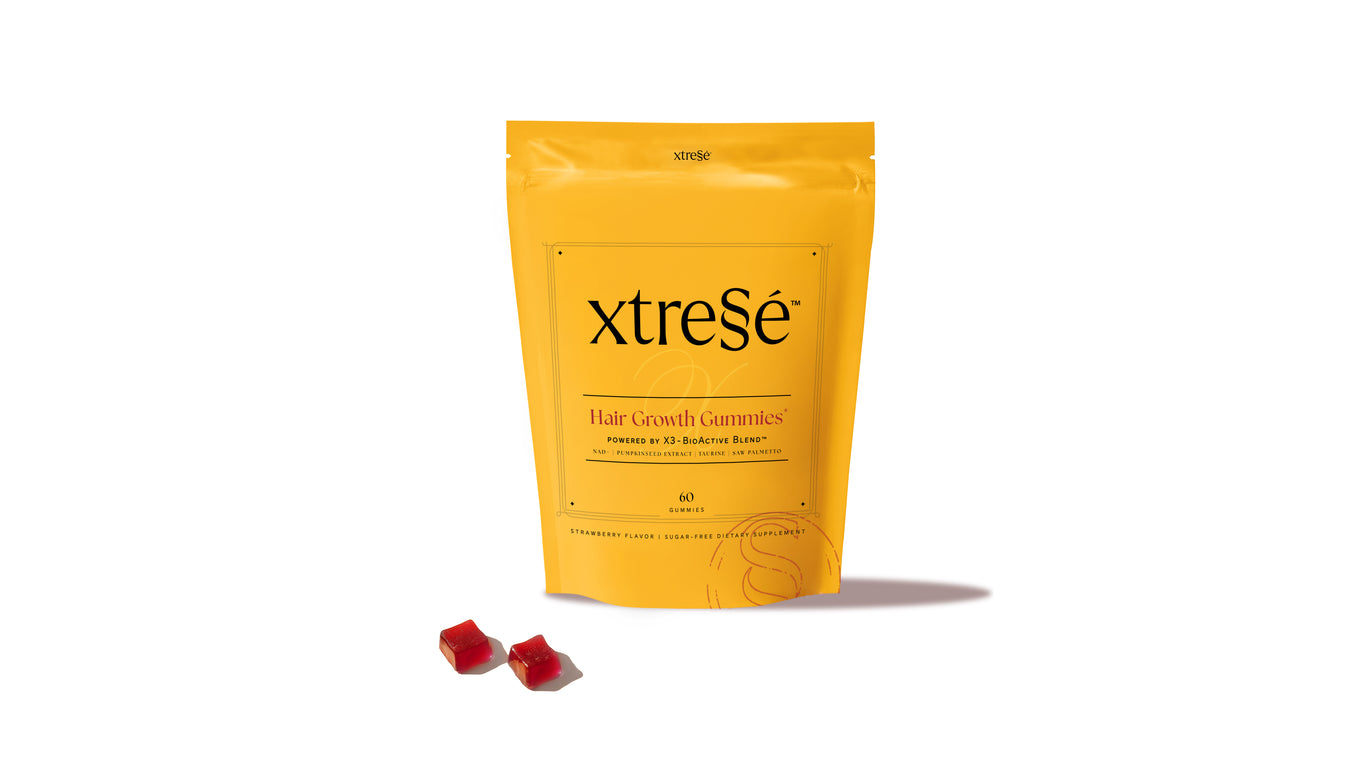 Yellow package of xtresé hair growth gummies on a white background
